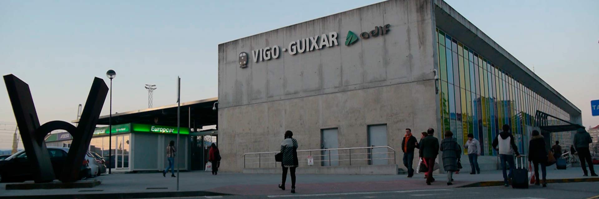 Modern exterior of Vigo Guixar station with people moving around it.
