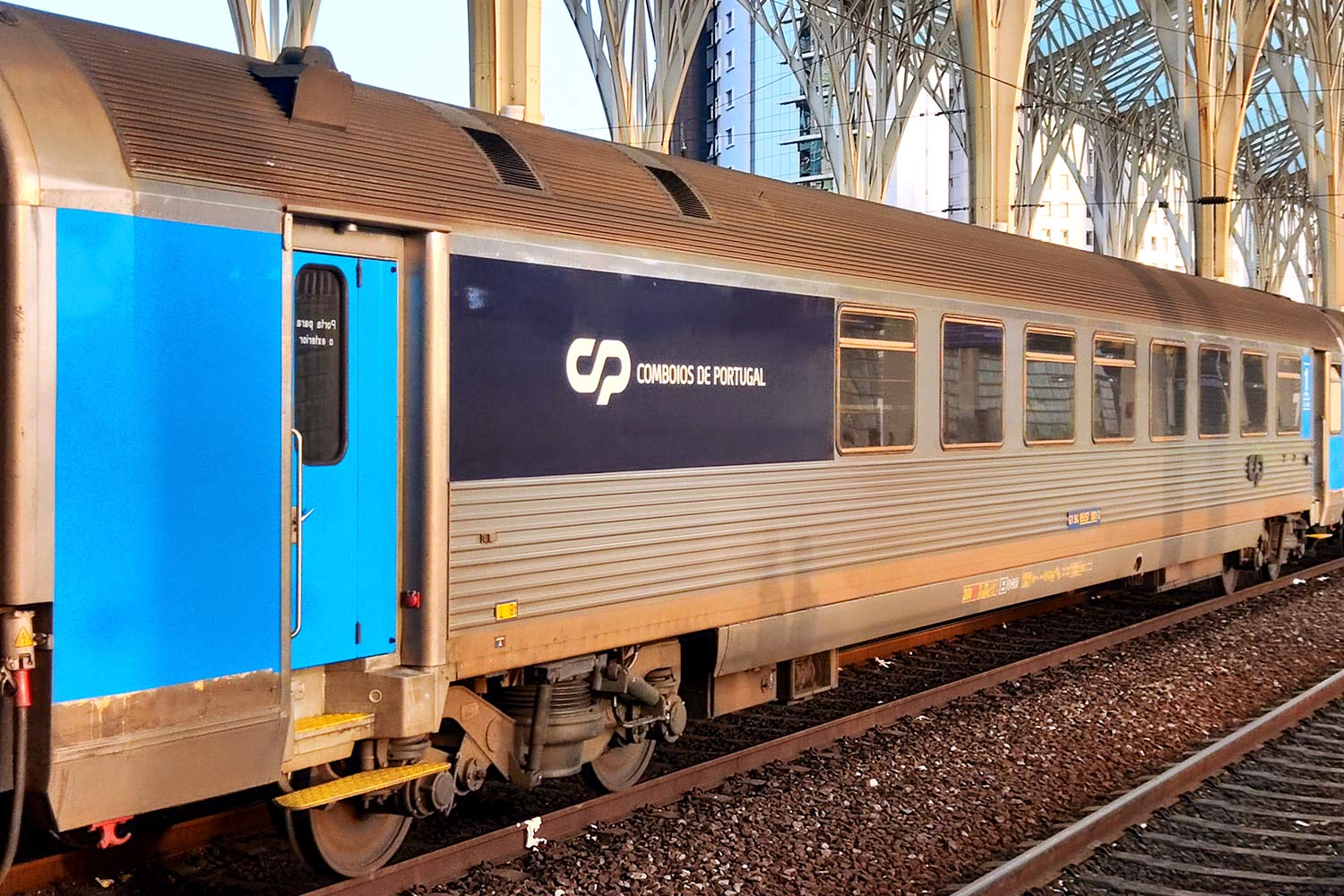 1st class with bistro Corail coach with blue and gray livery stopped at the station.