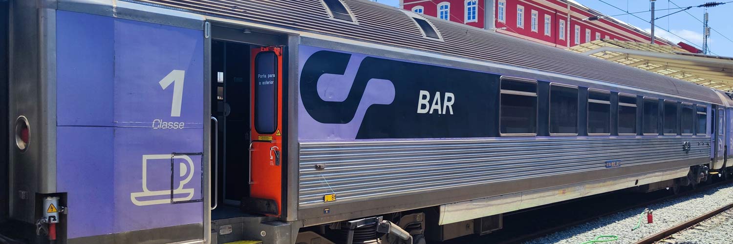 1st class with bistro Corail coach with purple, black and gray livery stopped at the station.