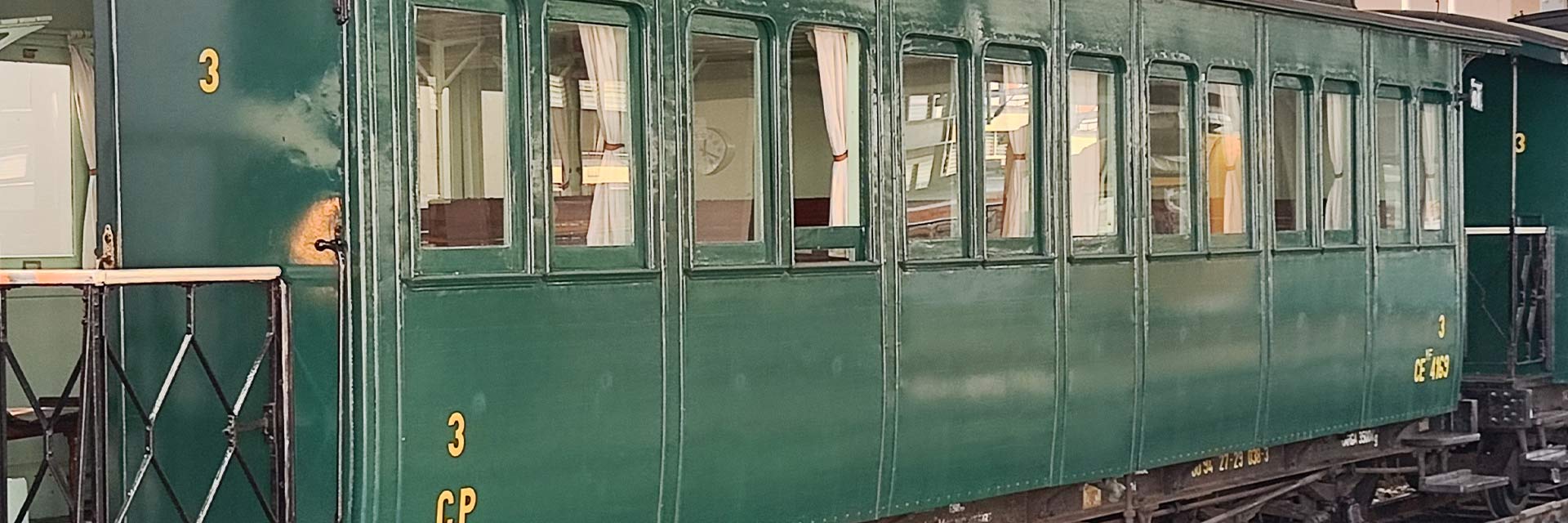 CEyf 4169 narrow gauge passenger coach with green livery stopped at the station.
