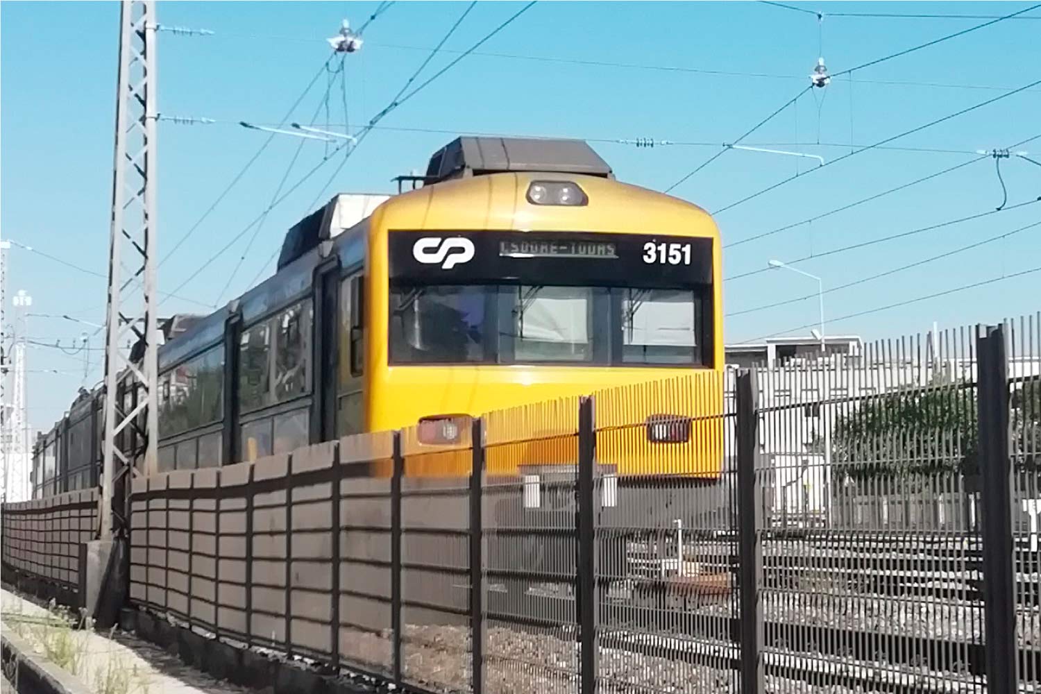 Lisbon urban train with yellow and gray livery running in the Cascais line.