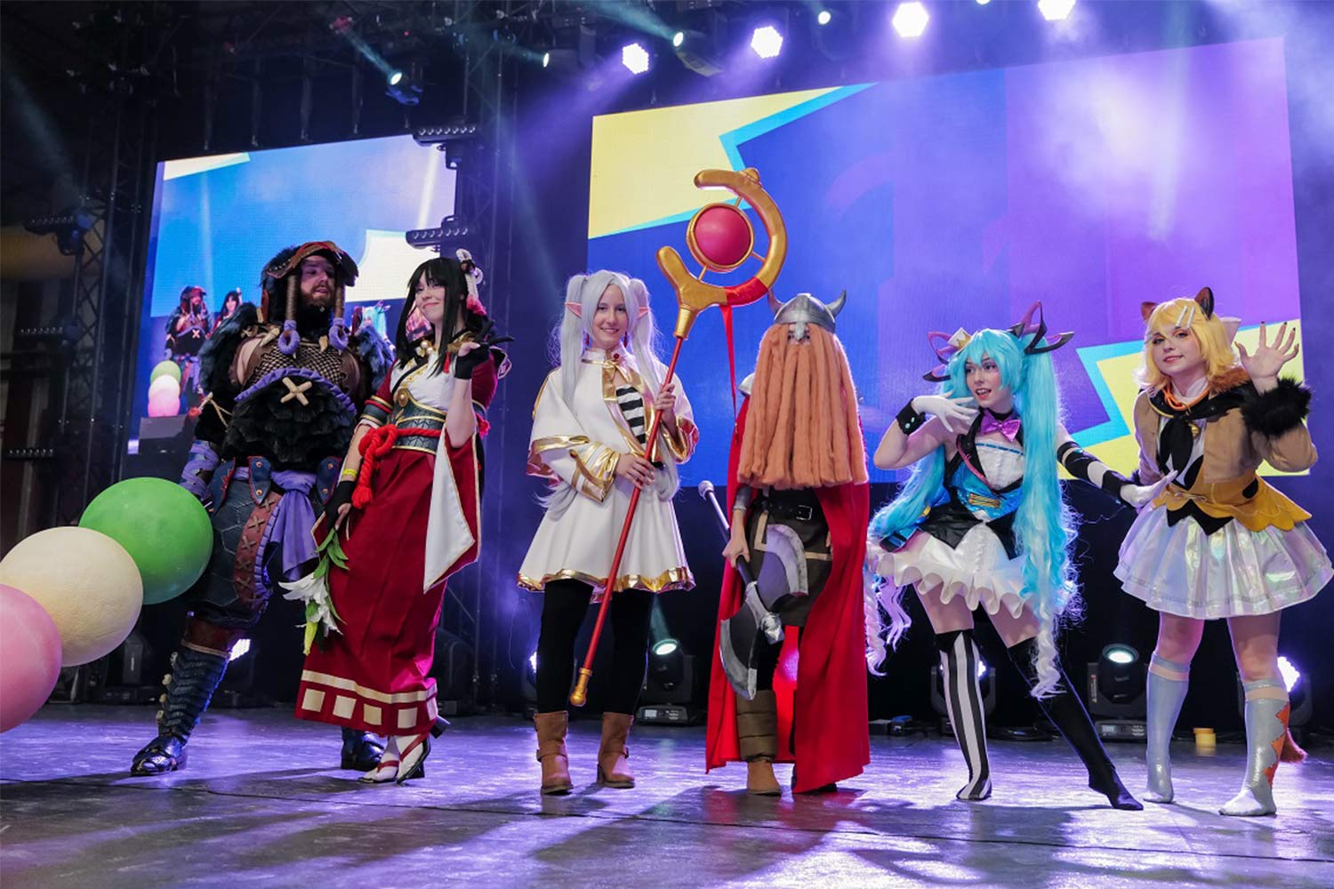 Group of masked people on stage.