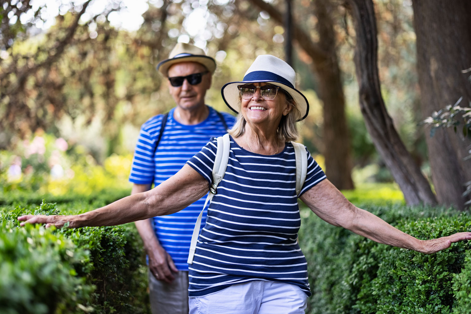  Senior couple hugging and sitting on a park bench.
      